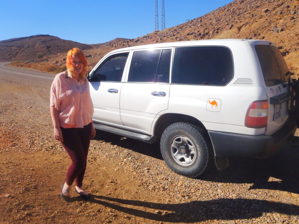 JJ sstood next to a car in Morocco