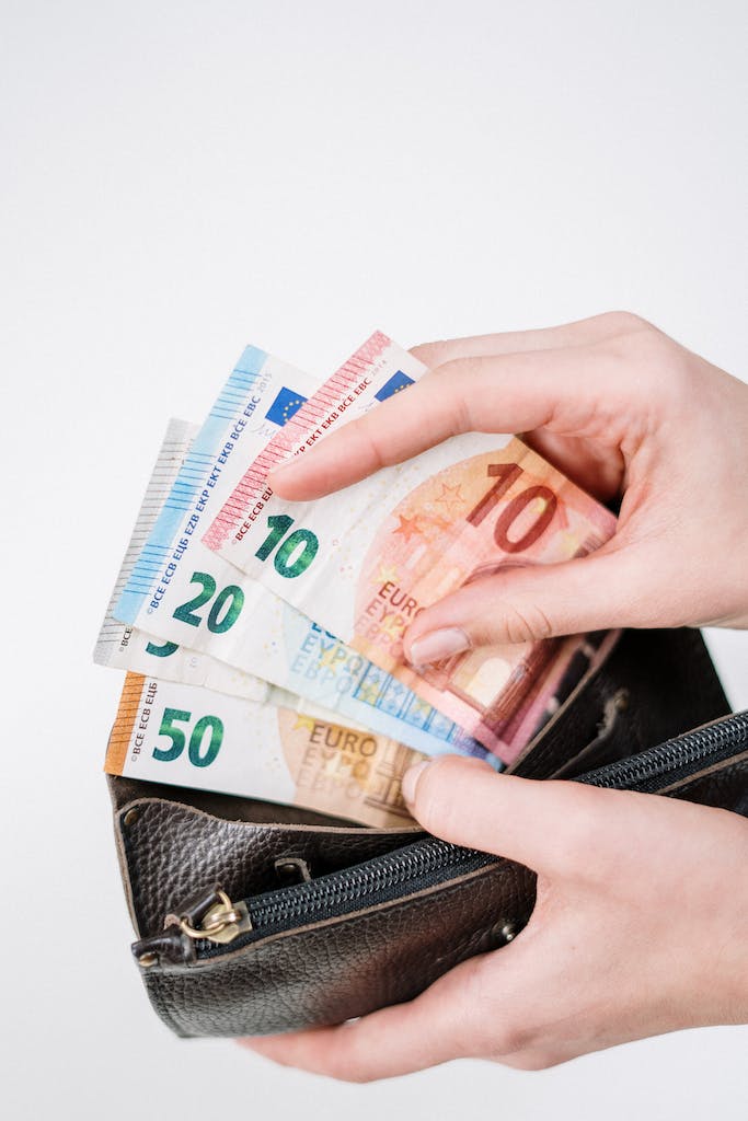 woman taking euros out of a wallet
