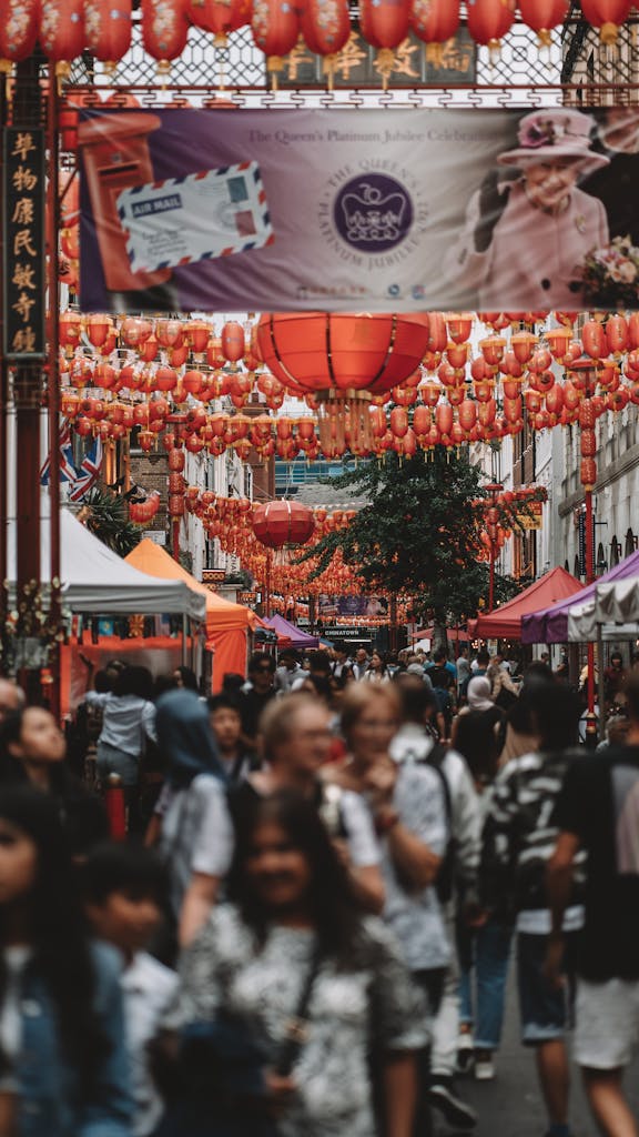 People Walking on a Street with Red Lanterns in Chinatown in London, England