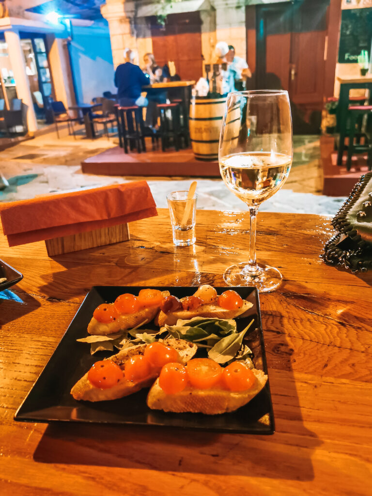 wine and brushetta served outside in the old town of Pula