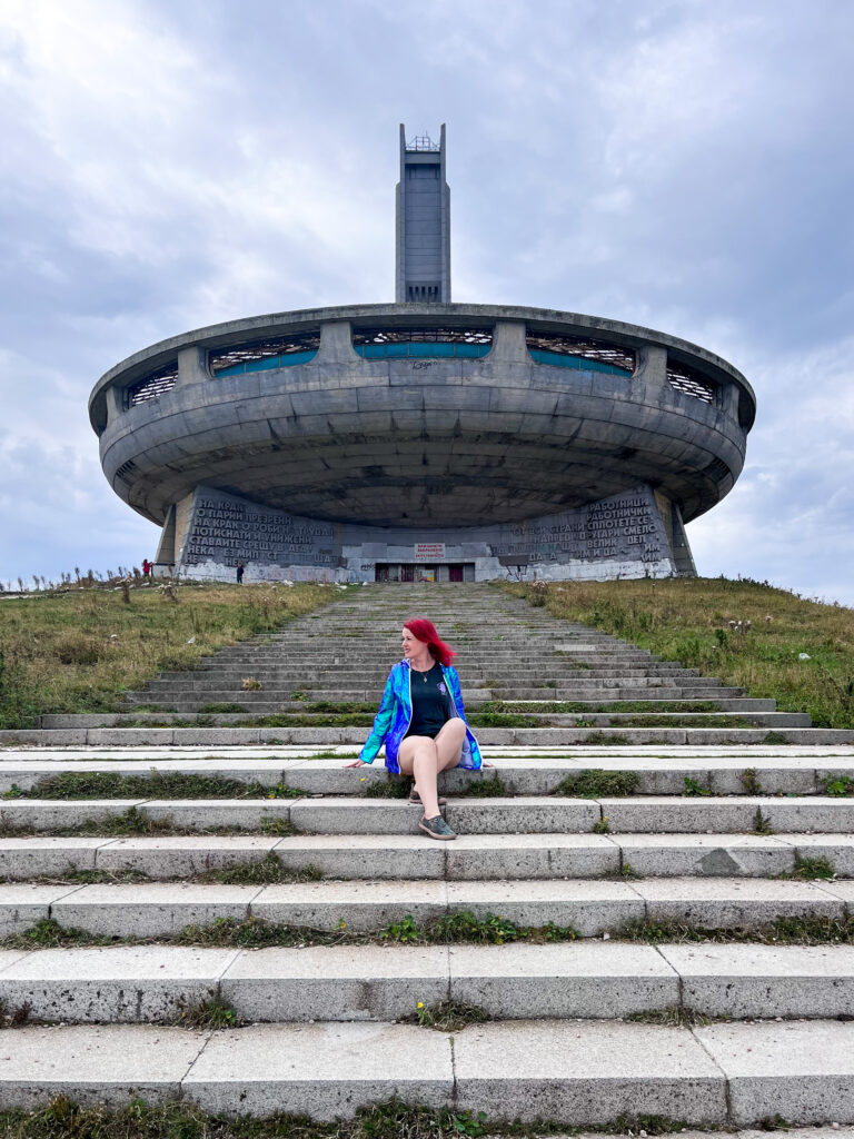 JJ sitting in front of the Buzludzha monument in Bulgaria